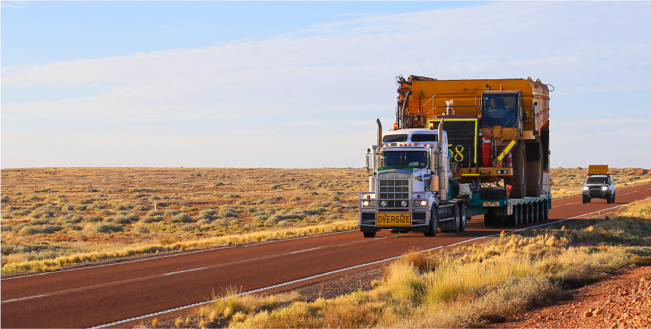 oversized truckload carrying heavy machinery featured image