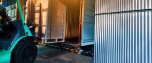 forklift loading pallet onto truck