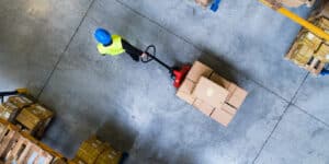 person moving boxes on a pallet jack