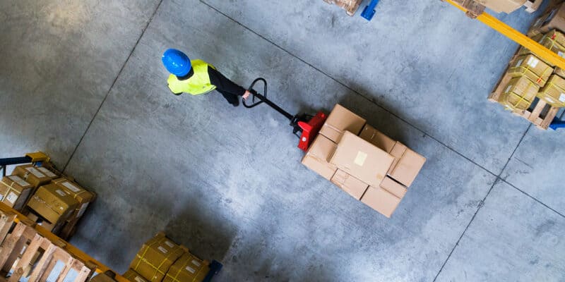 person moving boxes on a pallet jack