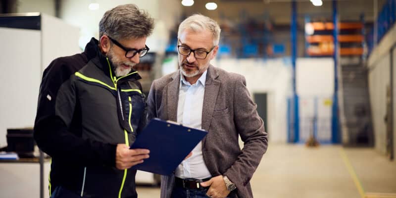 warehouse managers talking to each other