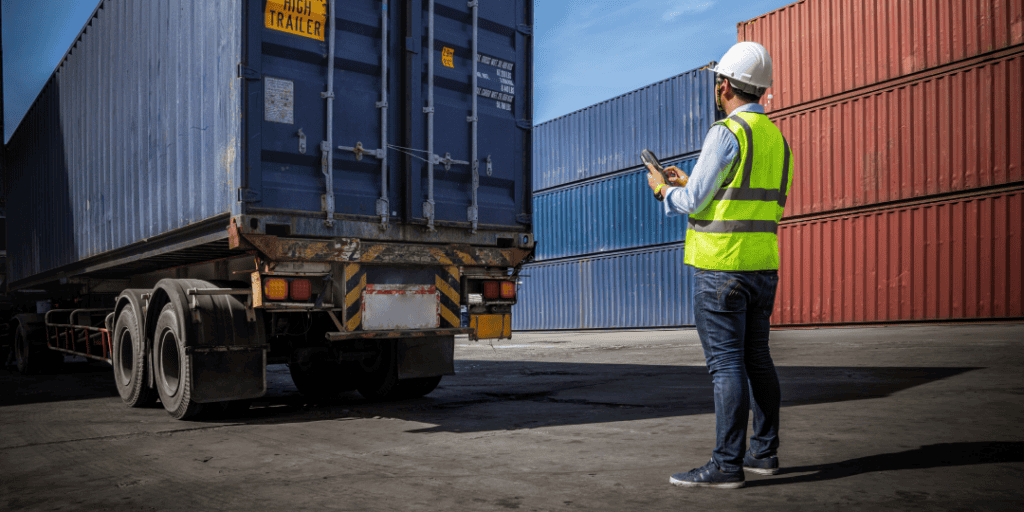person inspecting a drayage truckload